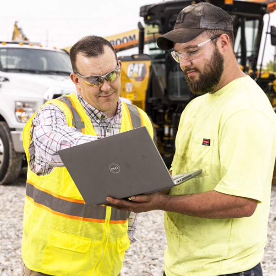 ohio machinery workers using laptop to figure out solutions